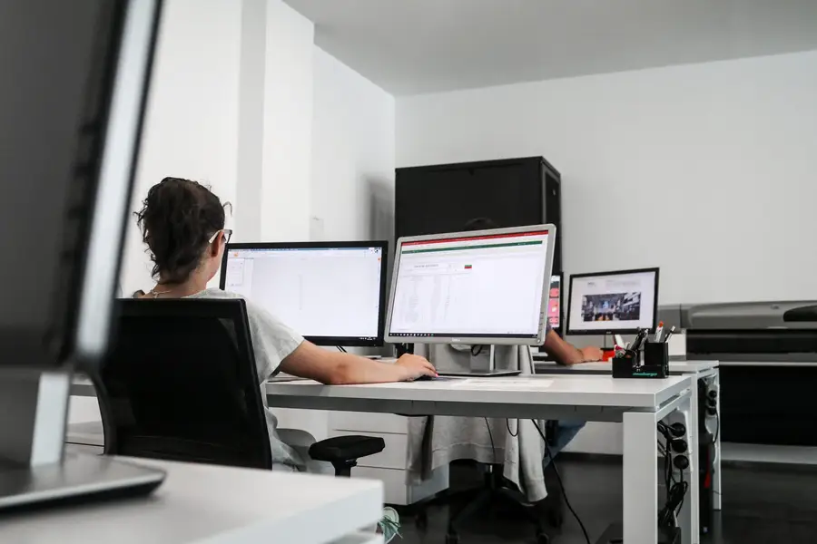 Posto de trabalho com lista de materiais e desenho 2D de molde no ecrã
